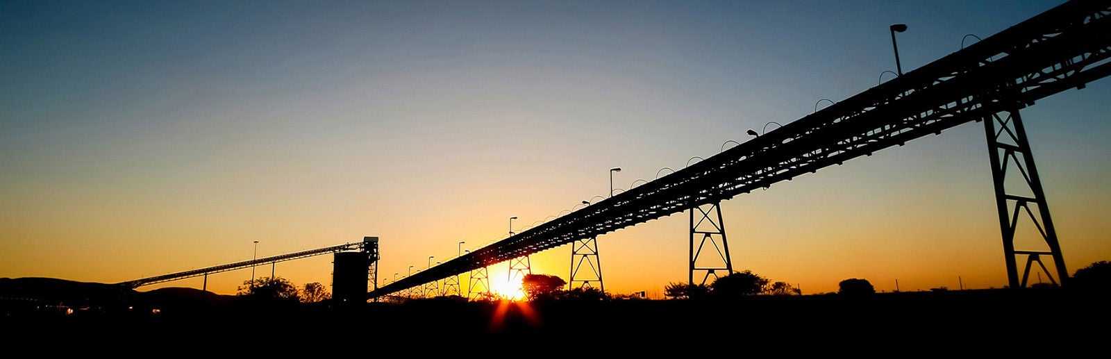 Silhouette Of A Mining Silo And Conveyor Belts